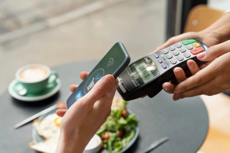 person-paying-using-nfc-technology-768x512